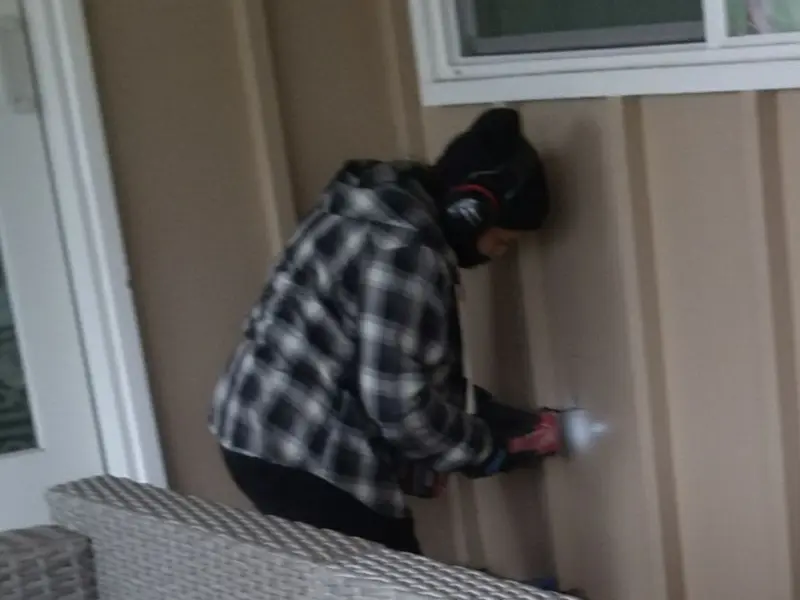 Professional electrician installing an exterior outlet in Wright